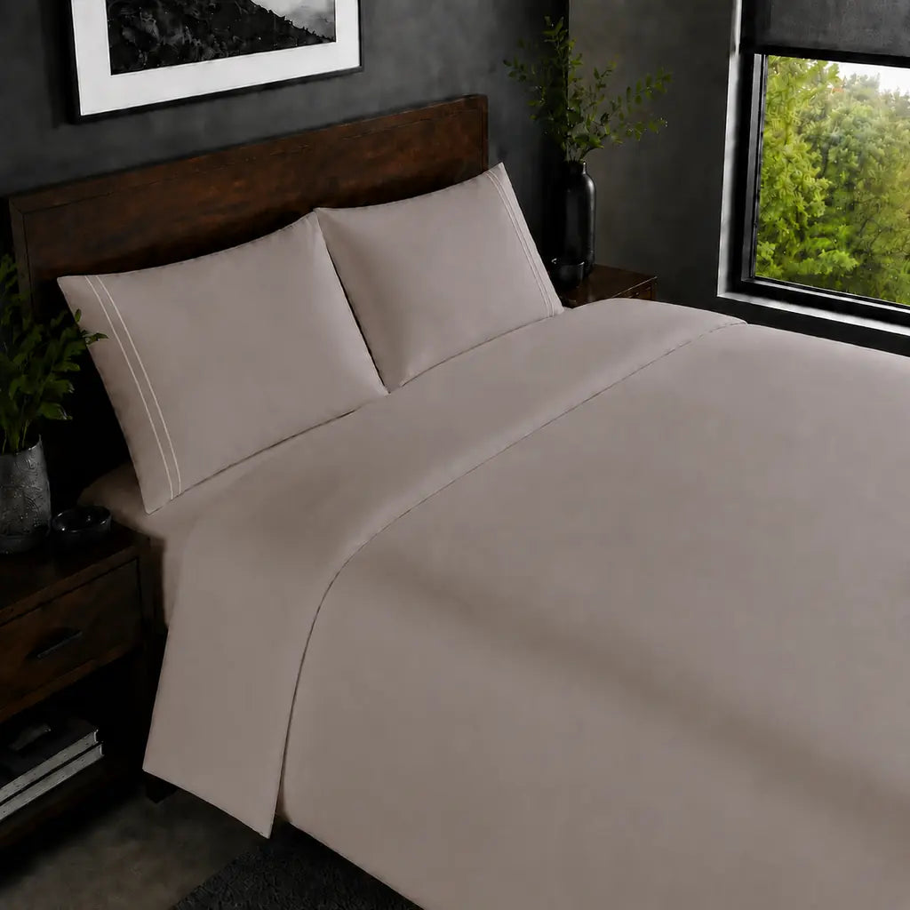 Stone 200TC plain duvet cover with Cream two row satin stitch - on the bed - Linen and Co