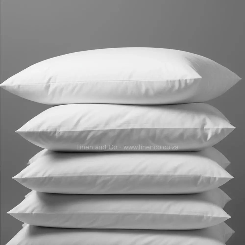 White goose down pillow from Linen and Co luxury hospitality collection, professional product photography showcasing premium pillow quality and comfort.