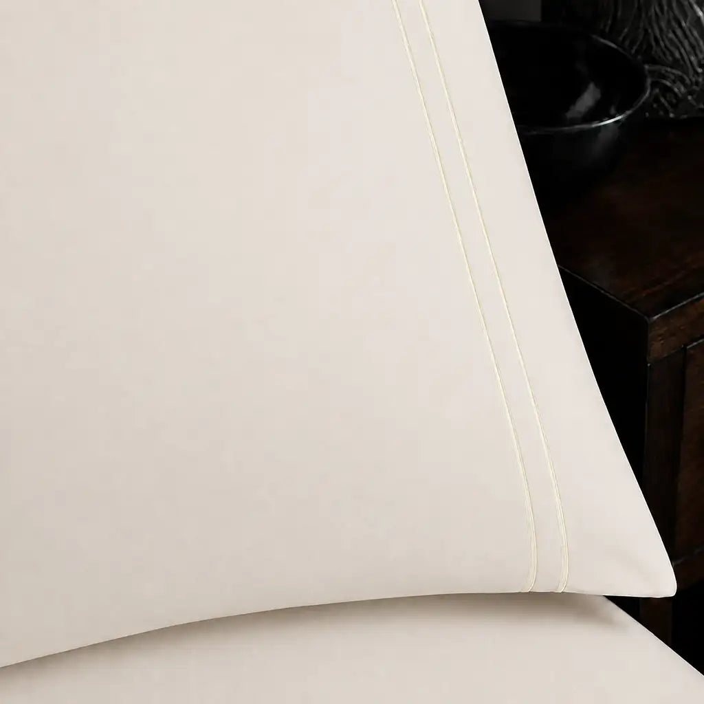 Close-up of cream pillowcase with two row cream satin stitch border by Linen and Co