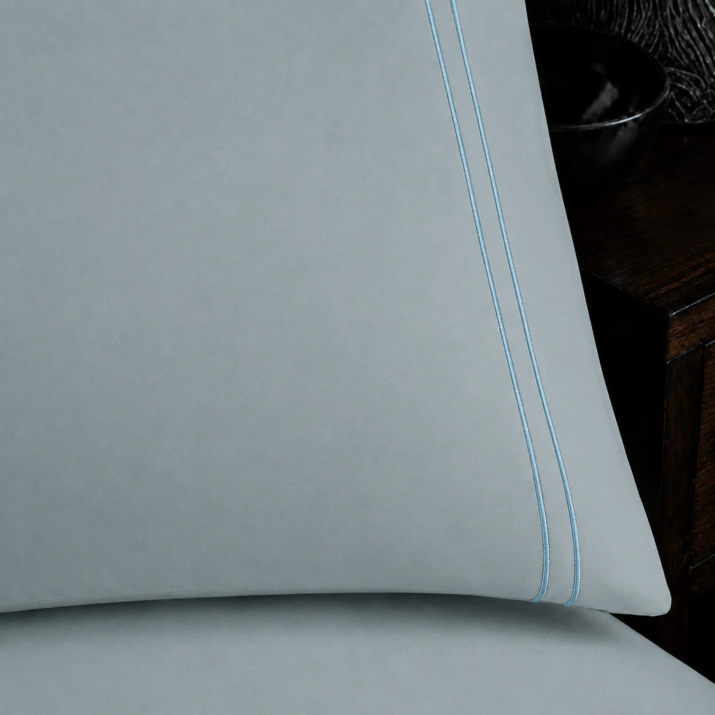 Close-up of duck egg pillowcase with two row duck egg satin stitch border by Linen and Co