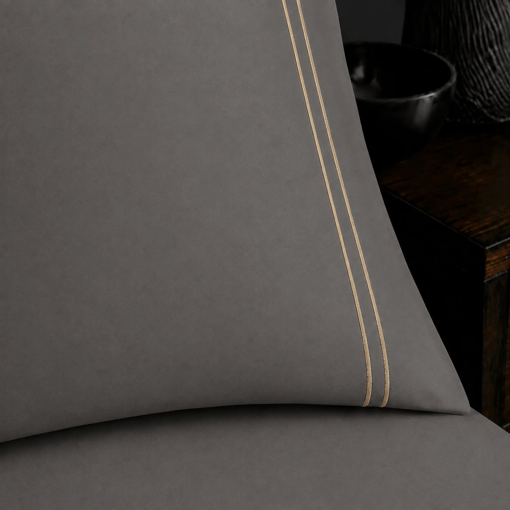 Close-up of grey pillowcase with two row stone satin stitch border by Linen and Co