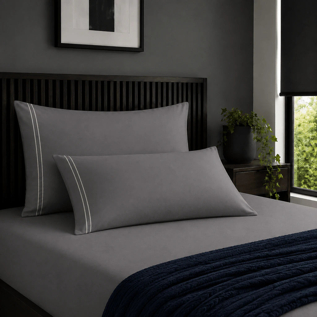 Plain grey 200TC 100% cotton percale pillowcases with two row cream satin stitch border by Linen and Co