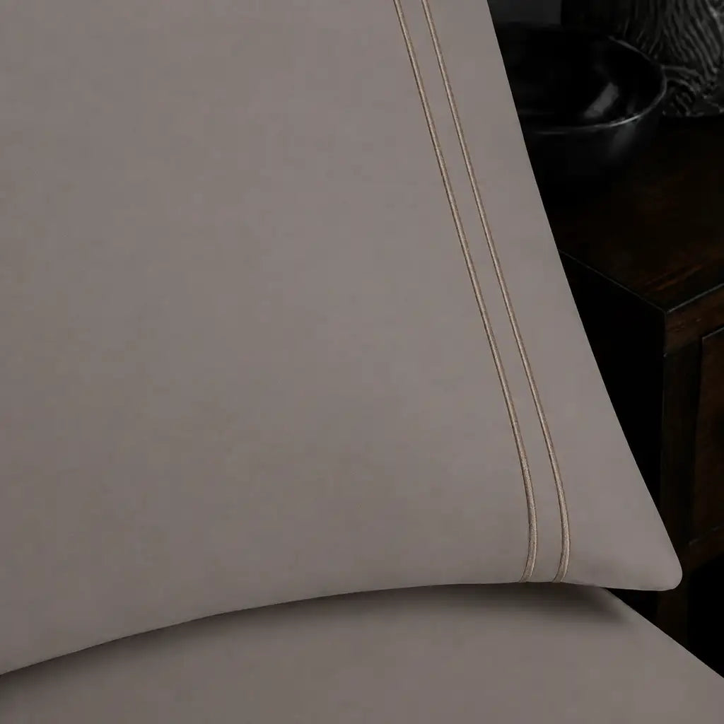 Close-up of stone pillowcase with two row stone satin stitch border by Linen and Co