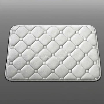 Platinum memory foam bath mat by Linen & Co on soft grey gradient background, 50x80cm luxury microfibre bathroom accessory with non-slip backing