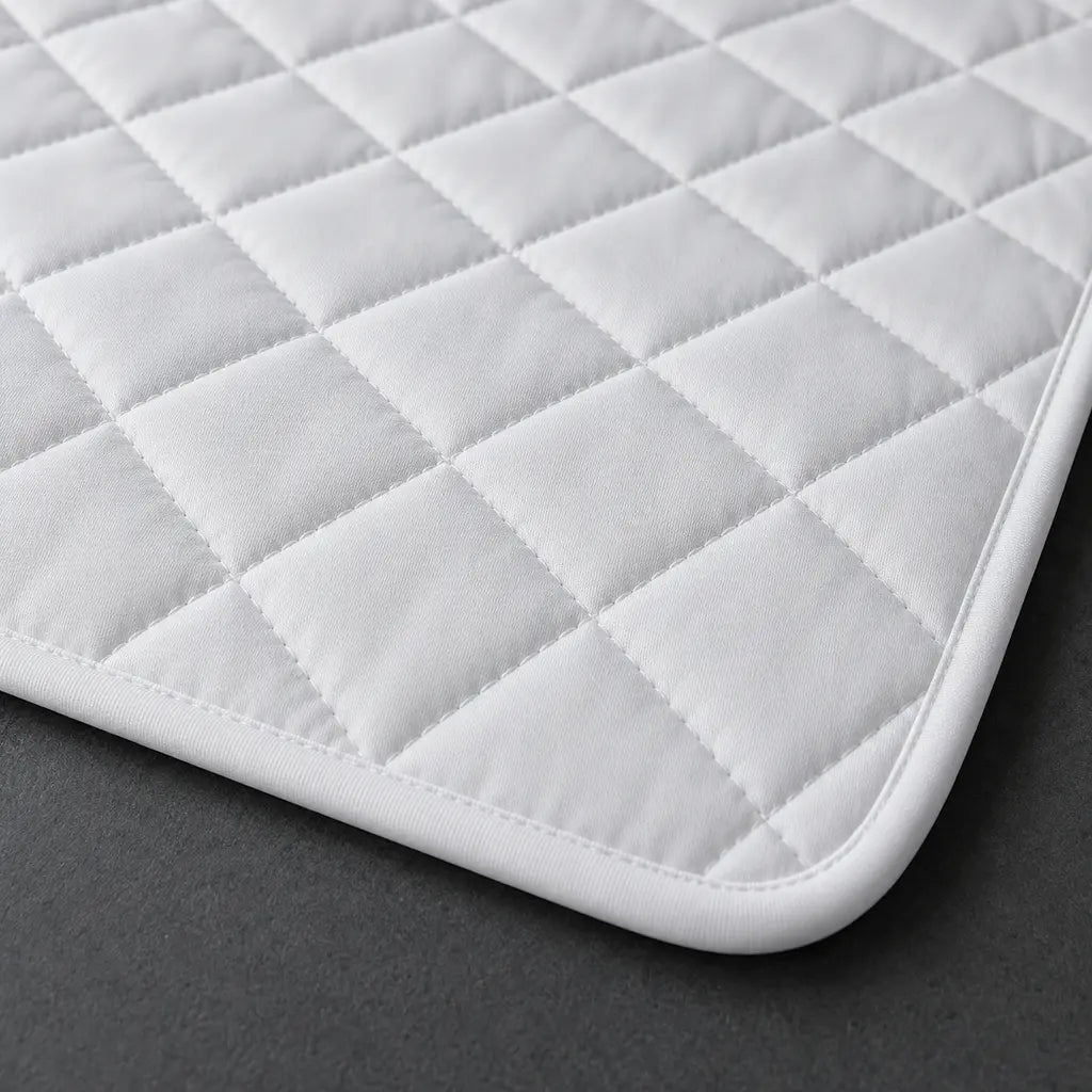 Close-up of white quilting on the Linen and Co Wetsafe mattress protector