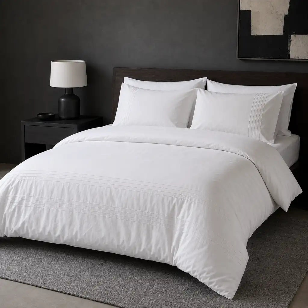 White cotton pintuck duvet cover set styled on a bed