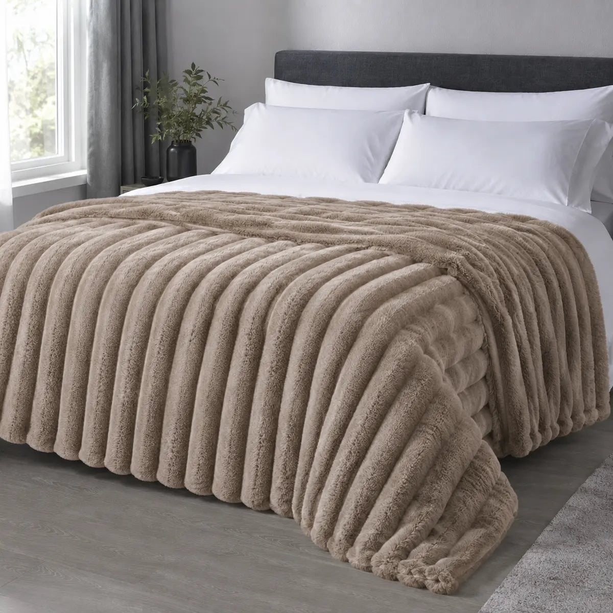 Camel ribbed faux fur blanket draped over a bed