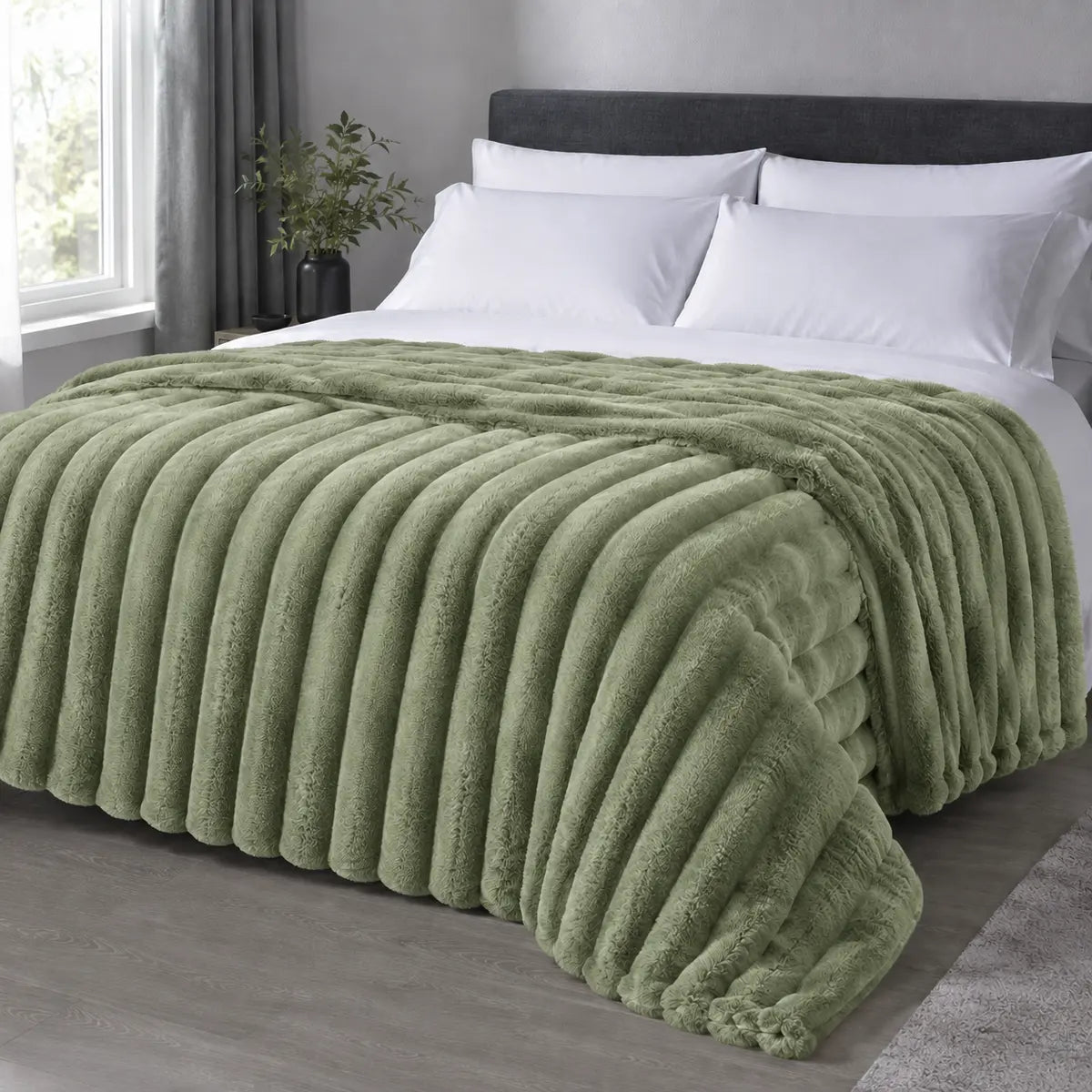 Pistachio ribbed faux fur blanket draped over a bed