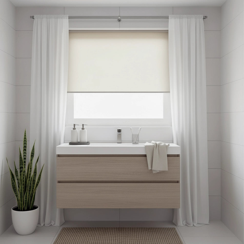 Sheer bathroom roller blind with white curtains in a modern bathroom by Linen and Co, featuring light wood vanity and neutral decor