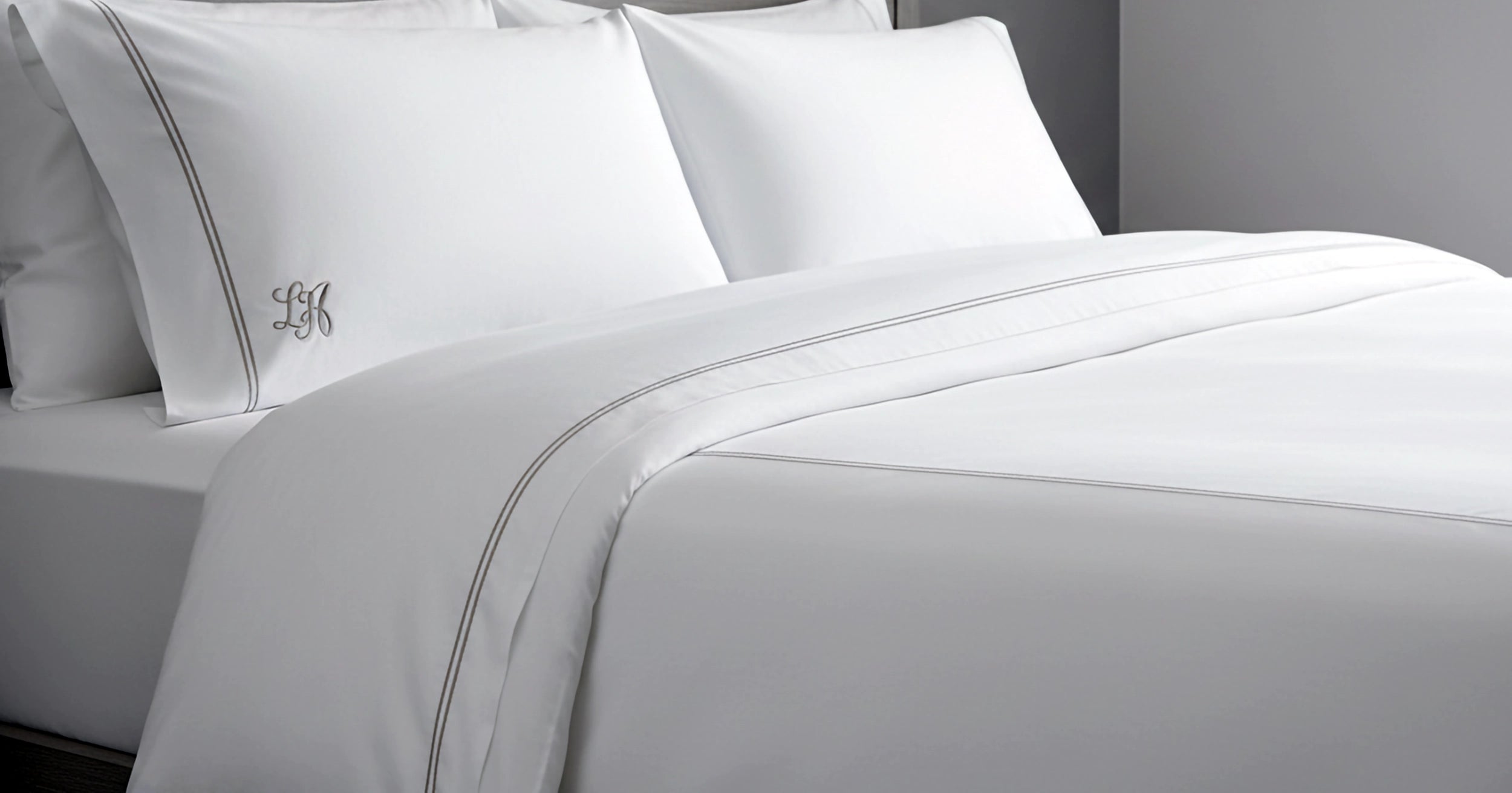 White luxury percale bed linen with satin stitch and embroidery by Linen and Co - premium hospitality bedding with elegant monogrammed pillowcases