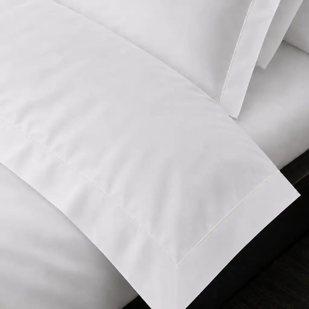 White Cotton 300TC Oxford duvet cover set with one row cream satin stitch — on-bed detail — Linen & Co