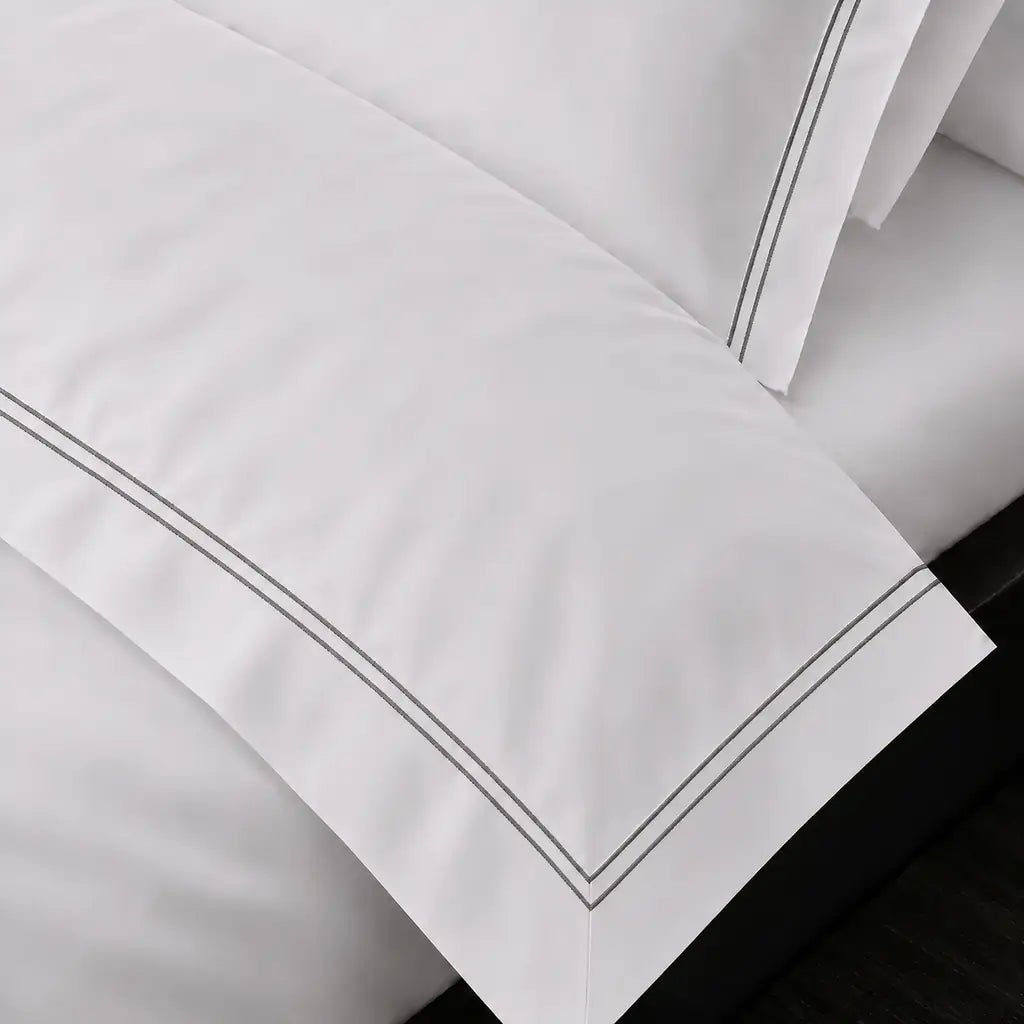 White Cotton 300TC Oxford duvet cover set with two row grey satin stitch — on-bed detail — Linen & Co