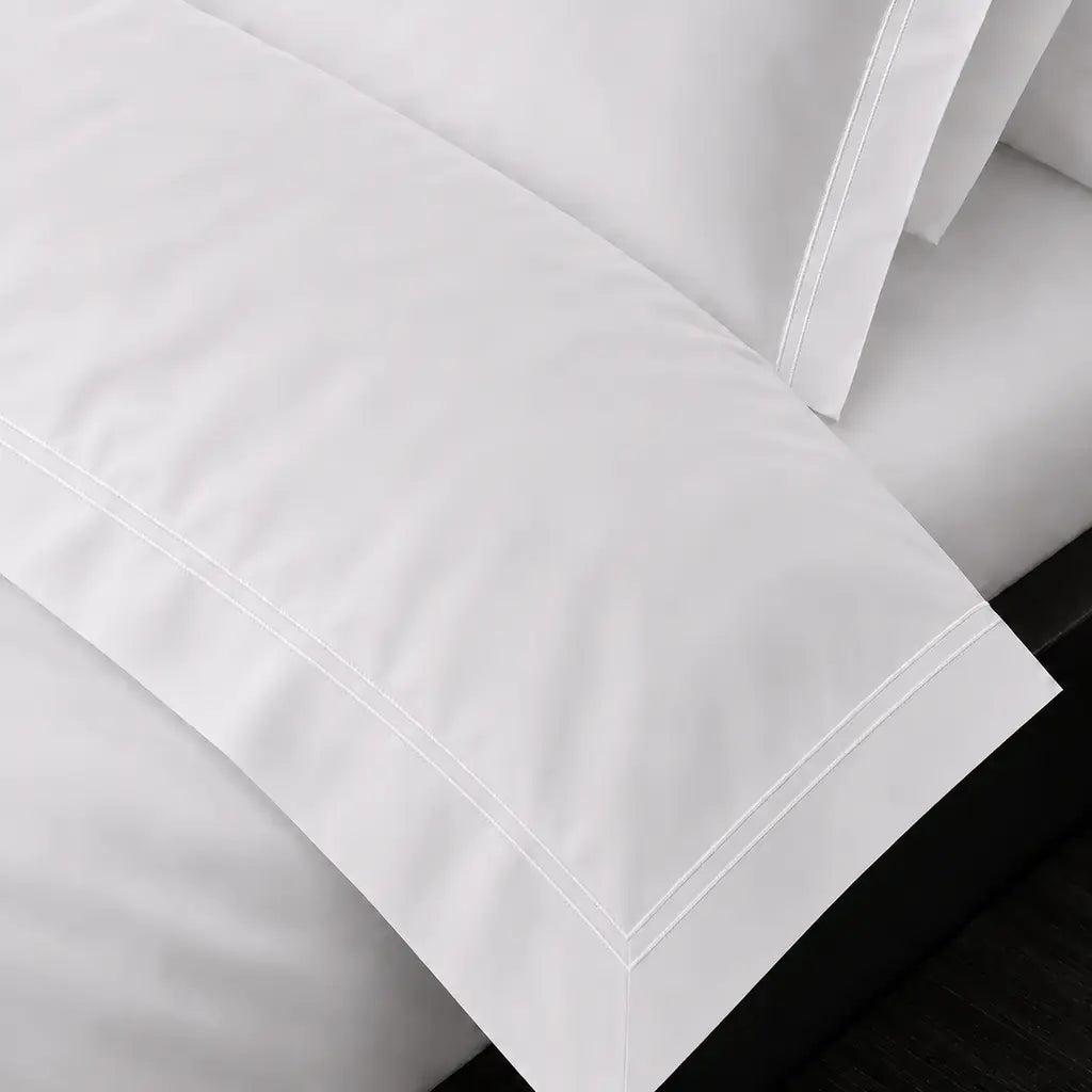 White Cotton 300TC Oxford duvet cover set with two row white satin stitch — on-bed detail — Linen & Co