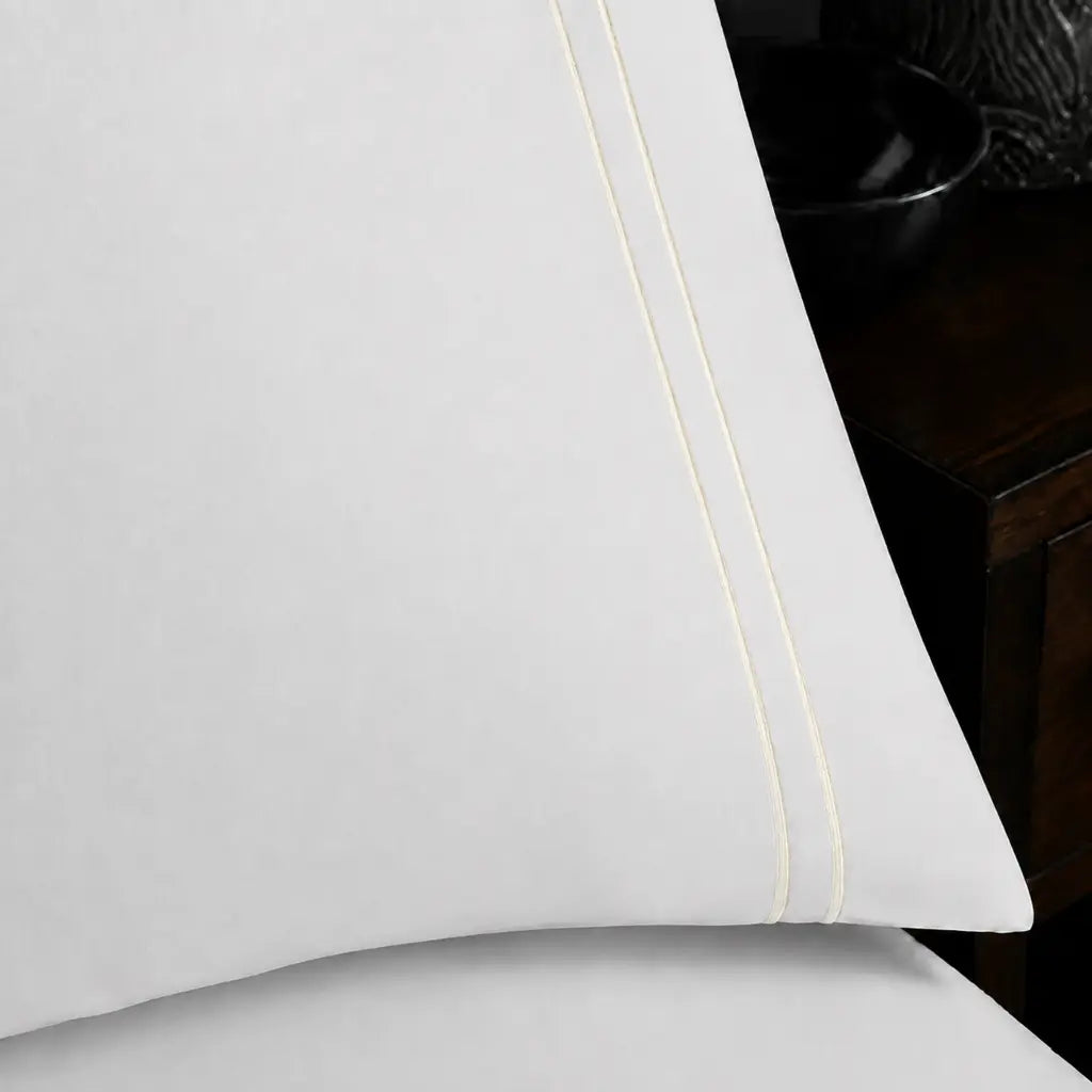 Close-up of White Polycotton Percale 200TC pillow case with Cream two-row satin stitch - Linen and Co