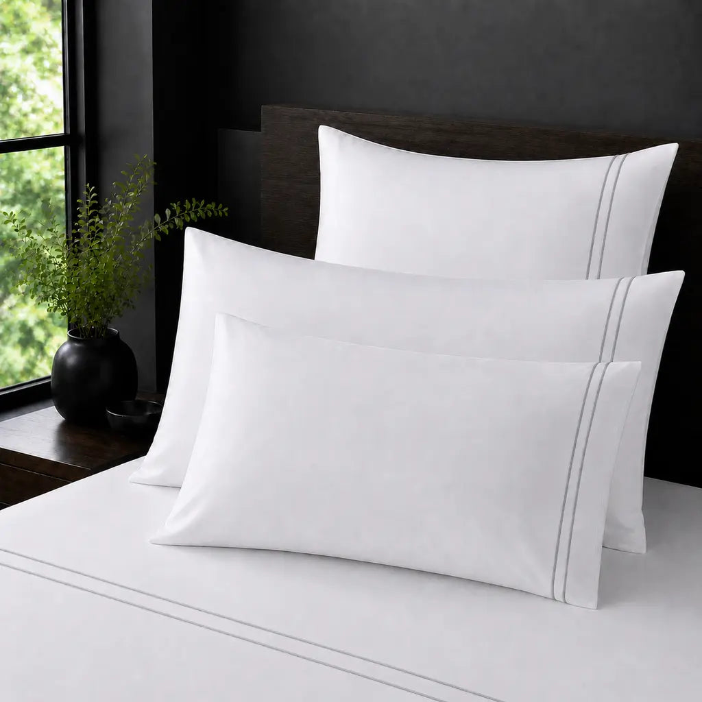 White Polycotton Percale 200TC pillow cases with grey two row satin stitch - on the bed - Linen and Co