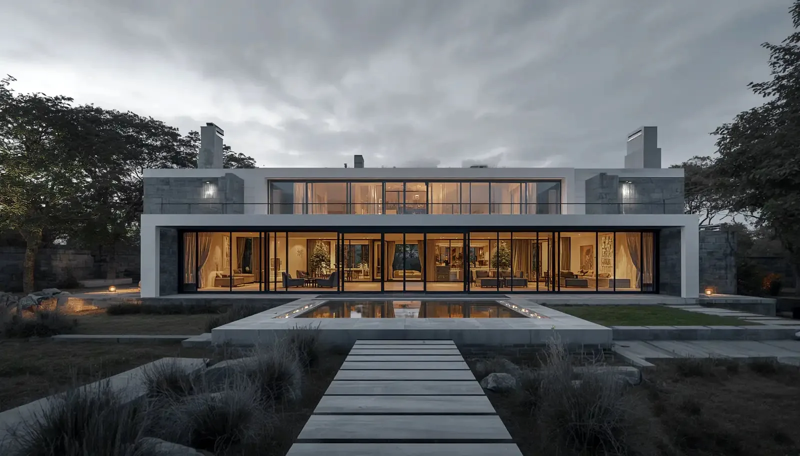 A modern lodge with a long glass front and a garden path at dusk