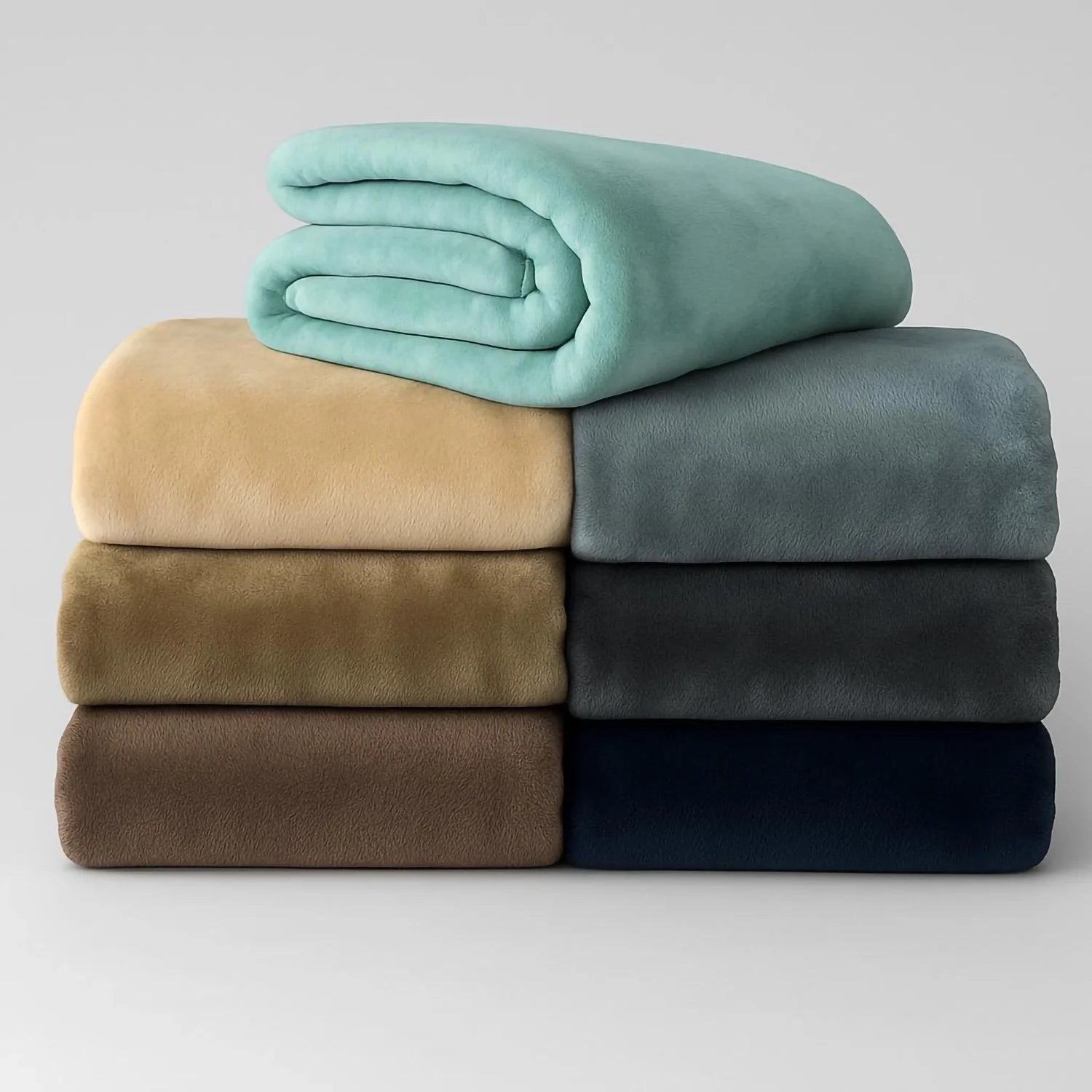 Stack of Assorted Colour Hotel Blankets on a grey background