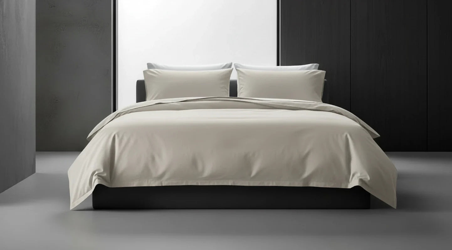 Cream bed linen by Linen and Co styled on a modern bed, showcasing sleek, premium bedding for hospitality and home.