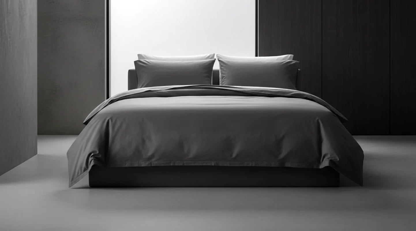 Grey bed linen by Linen and Co styled on a modern bed, showcasing sleek, premium bedding for hospitality and home.