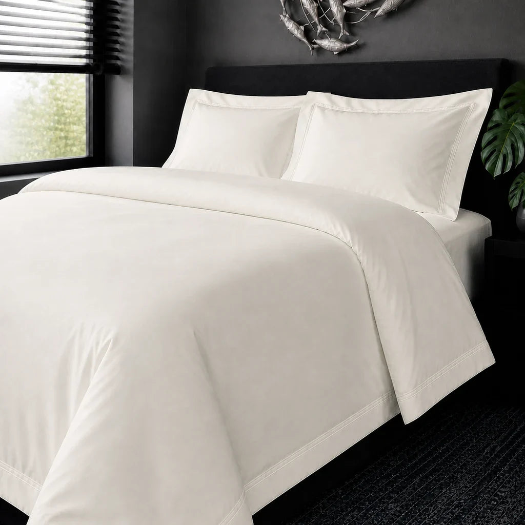 Cream cotton 200TC Oxford duvet cover set with cream two-row satin stitch – on-bed view | Linen & Co