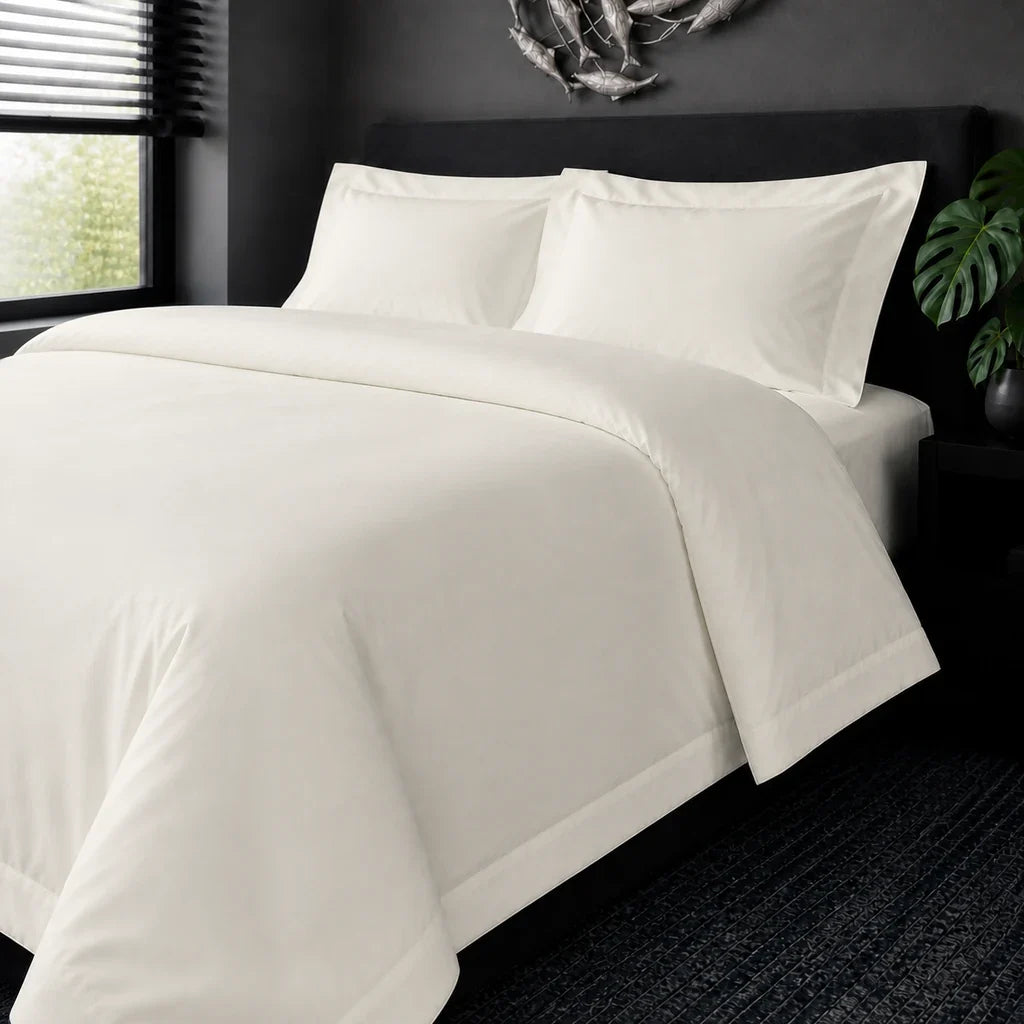 Cream cotton 200TC Oxford duvet cover set, no satin stitch – on-bed view | Linen & Co