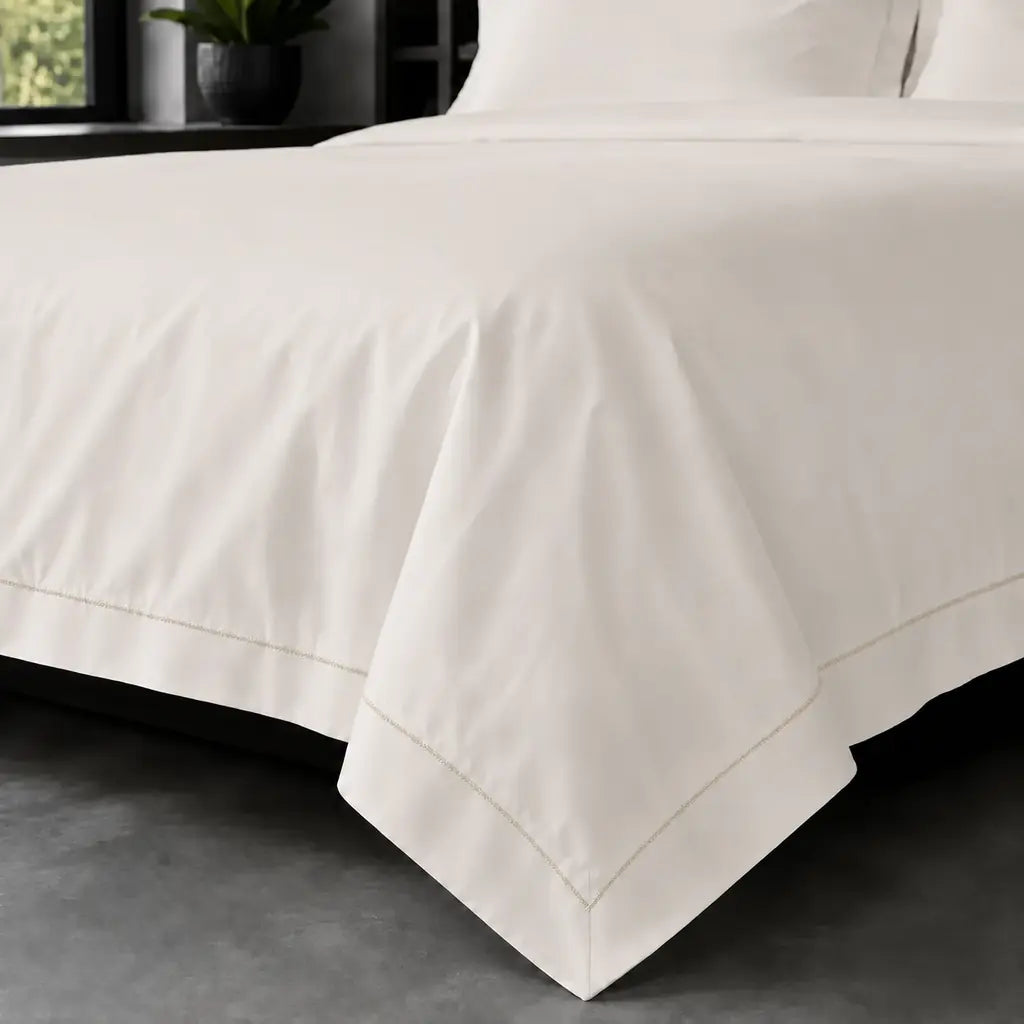 Cream polycotton percale 200TC Oxford duvet cover on bed with Stone one-row satin stitch - Linen and Co