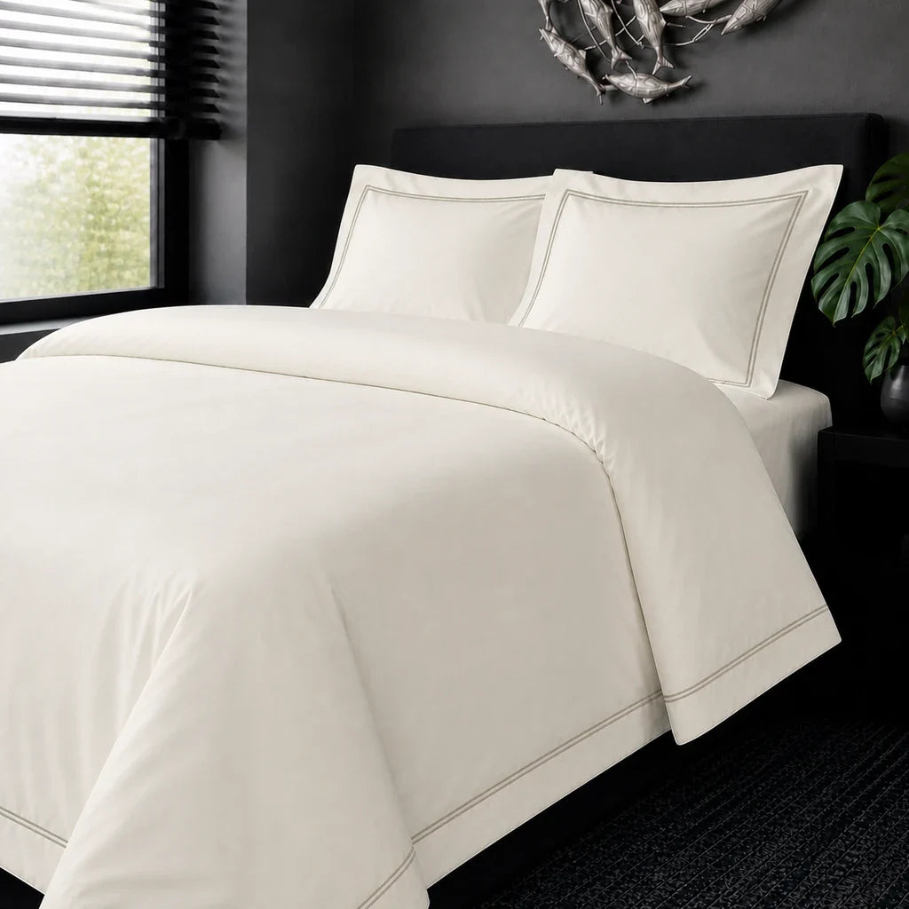 Cream cotton 200TC Oxford duvet cover set with stone two-row satin stitch – on-bed view | Linen & Co