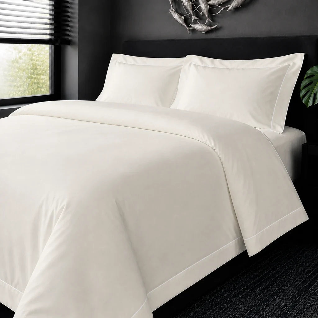 Cream cotton 200TC Oxford duvet cover set with white one-row satin stitch – on-bed view | Linen & Co