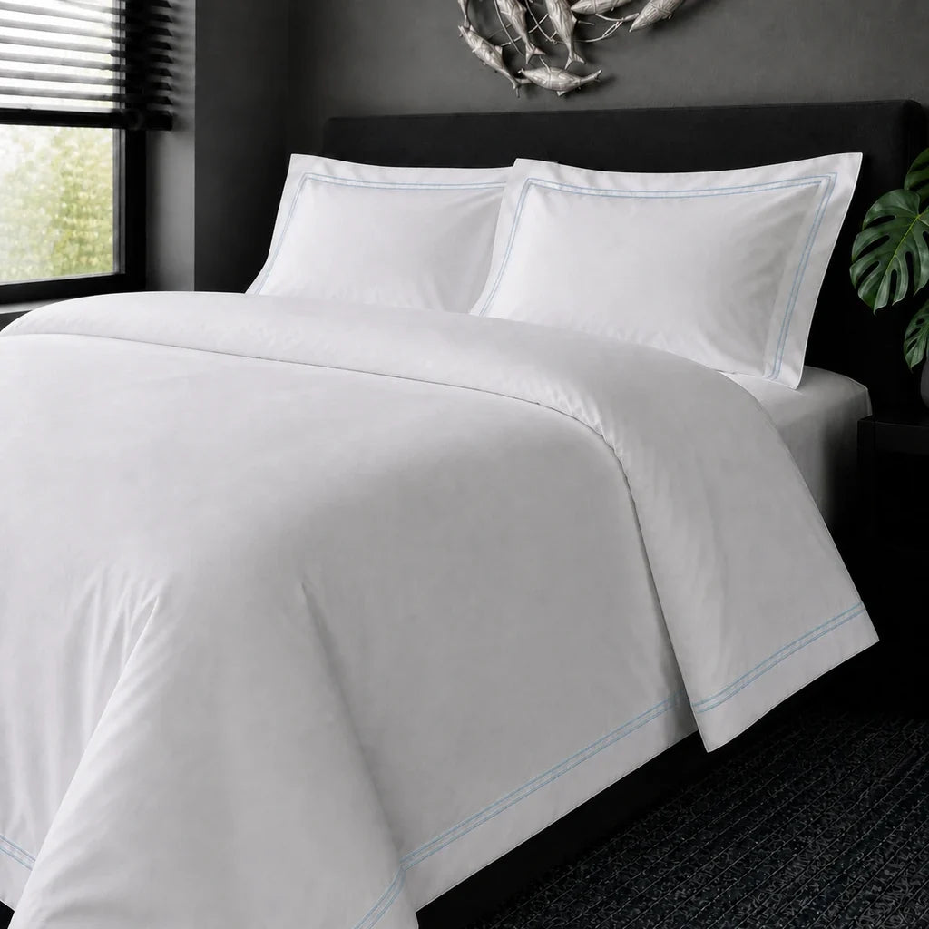White cotton 200TC Oxford duvet cover set with duck egg two-row satin stitch – on-bed view | Linen & Co