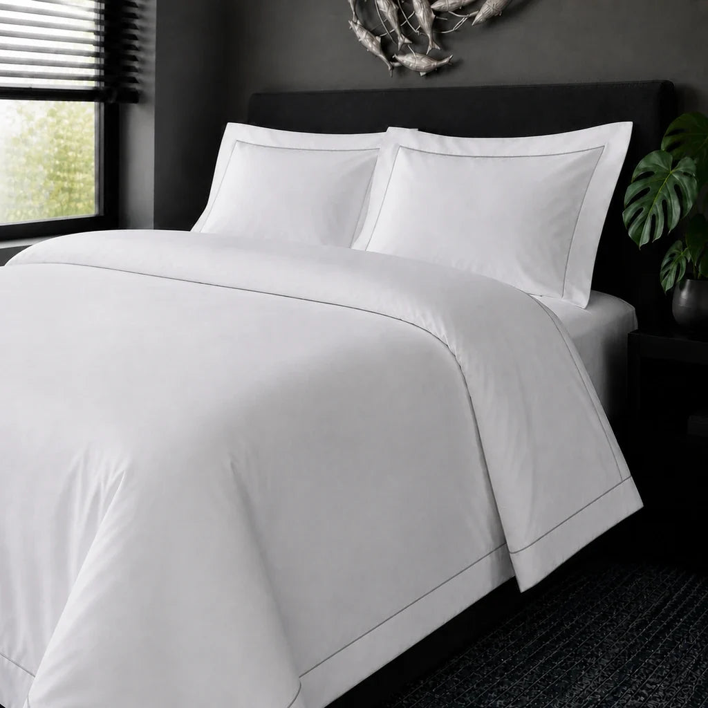 White cotton 200TC Oxford duvet cover set with grey one-row satin stitch – on-bed view | Linen & Co