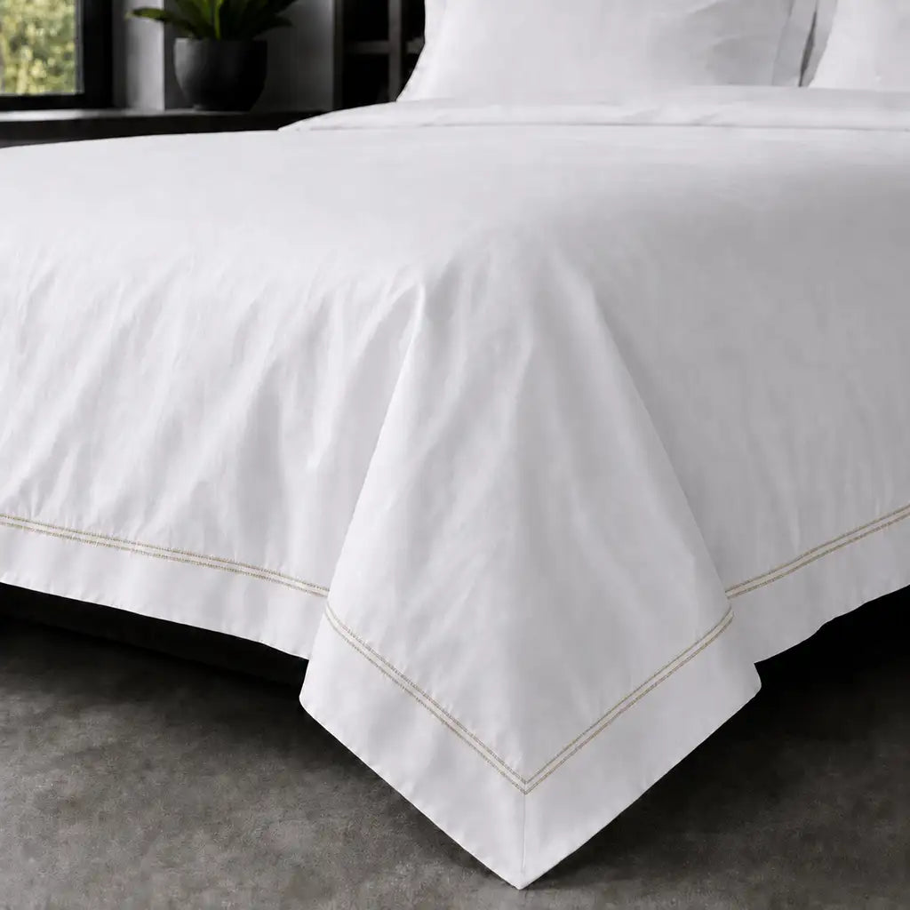 White polycotton percale Oxford duvet cover set with stone two-row satin stitch – on-bed view | Linen & Co