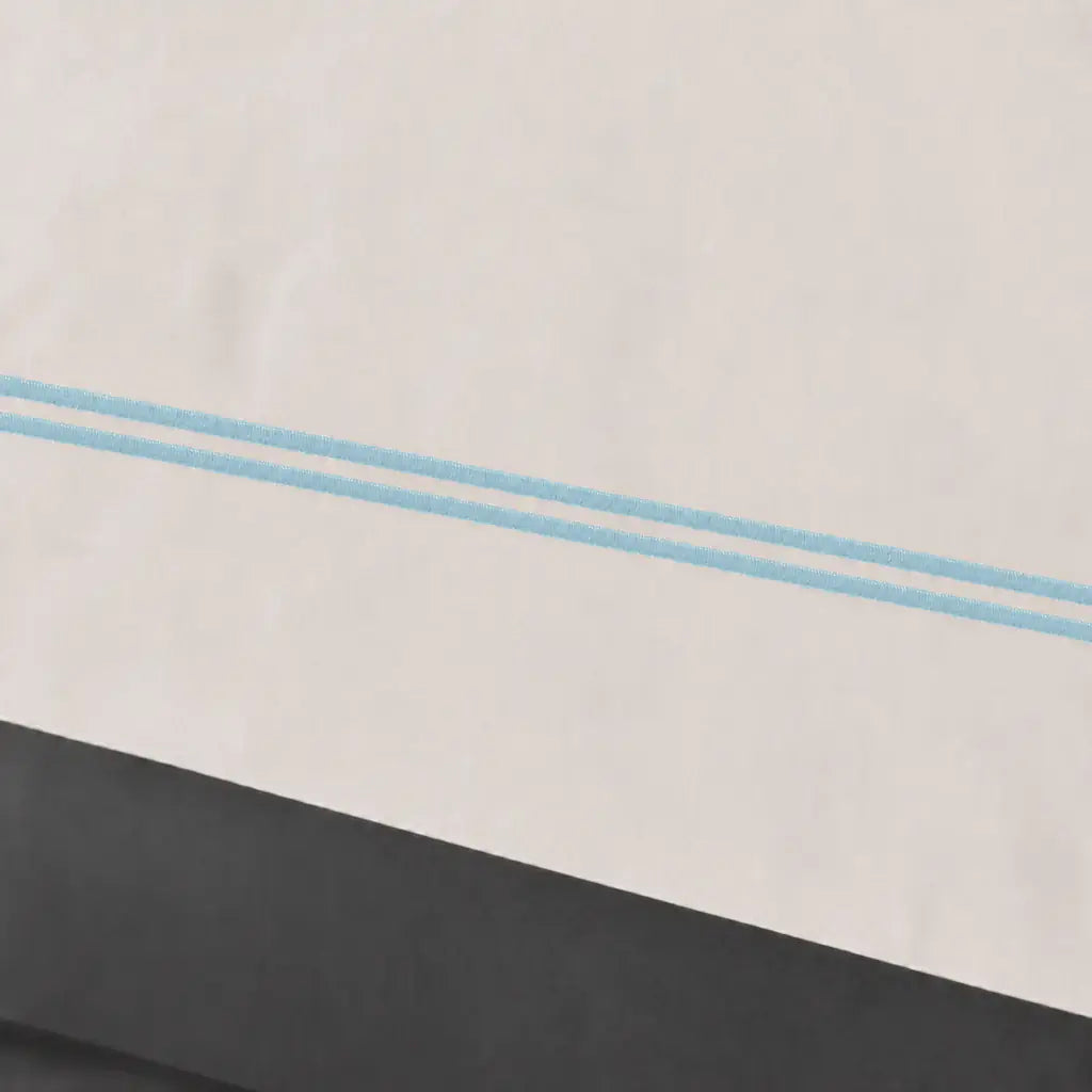 Close-up of cream polycotton percale 200TC Oxford cuff with Duck Egg two-row satin stitch - Linen and Co