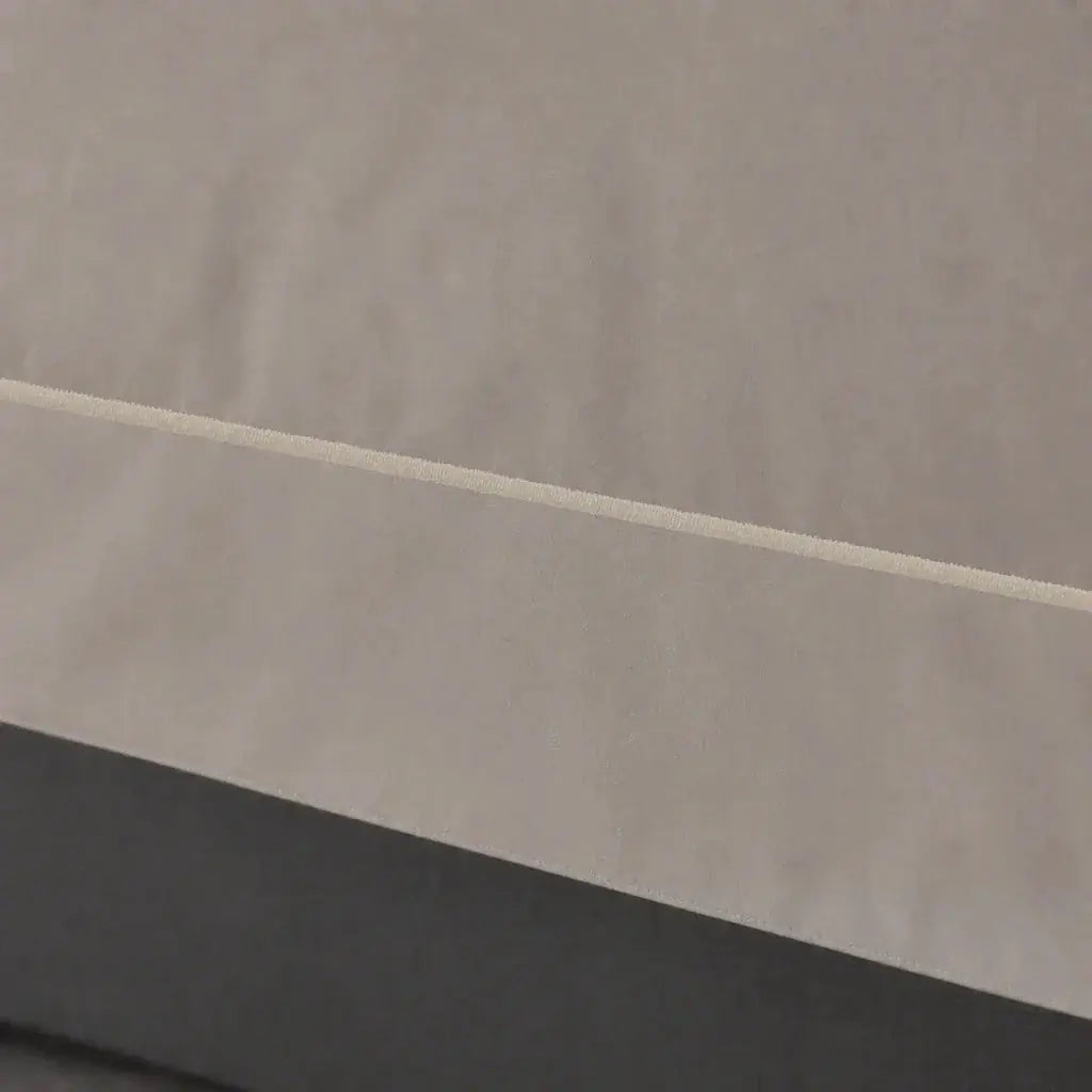 Close-up of the Stone Cotton 200TC Oxford duvet cover border with stone one-row satin stitch.