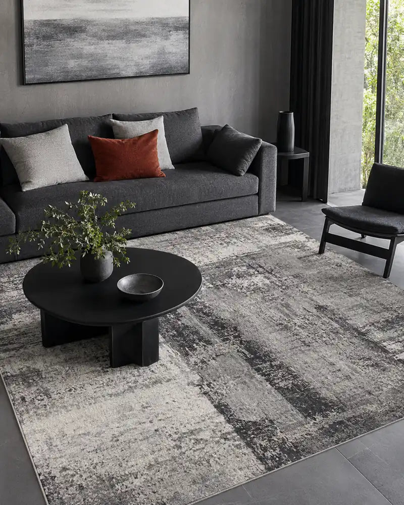 Grey abstract rug in a charcoal contemporary lounge