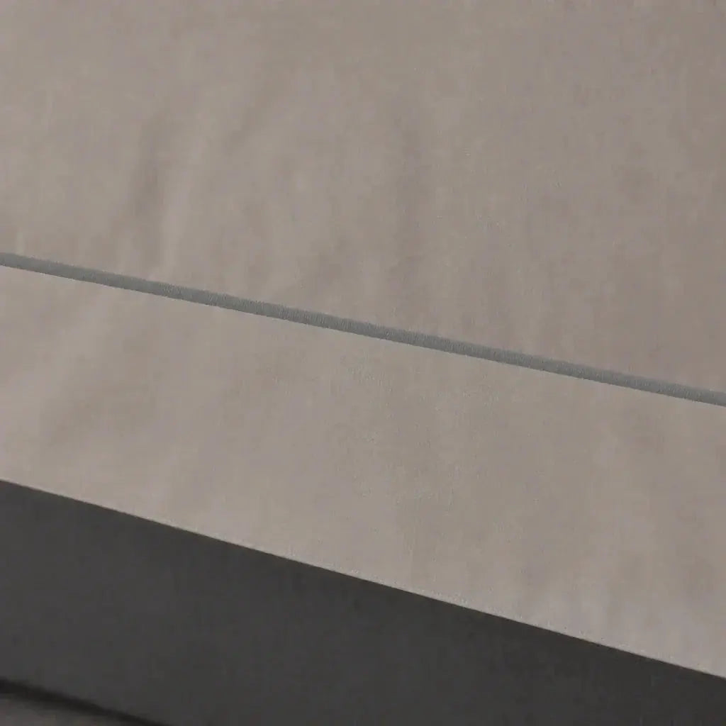Close-up of the Stone Cotton 200TC Oxford duvet cover border with grey one-row satin stitch.