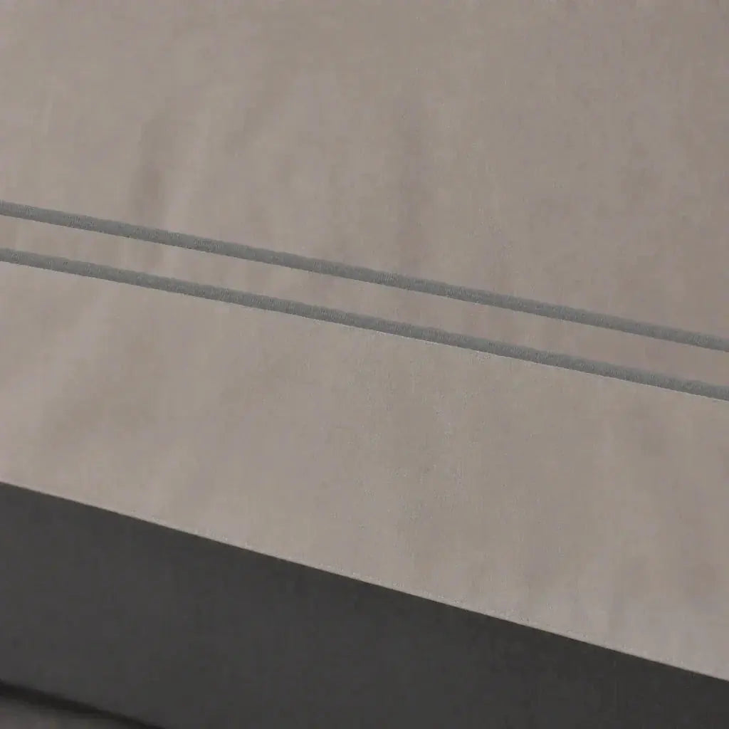 Close-up of the Stone Cotton 200TC Oxford duvet cover border with grey two-row satin stitch.