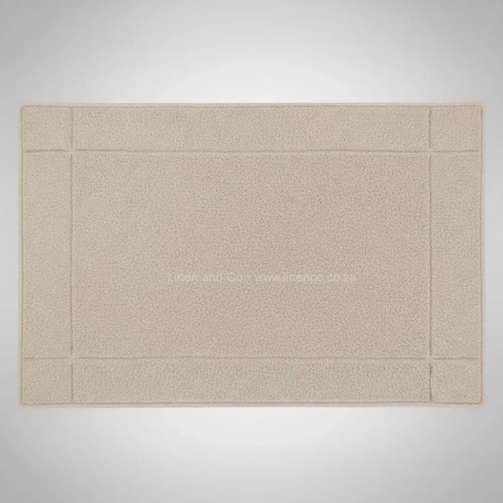High-quality beige bath mat from Linen and Co's Glodina range, illustrating superior absorbency and commercial-grade performance for hospitality environments