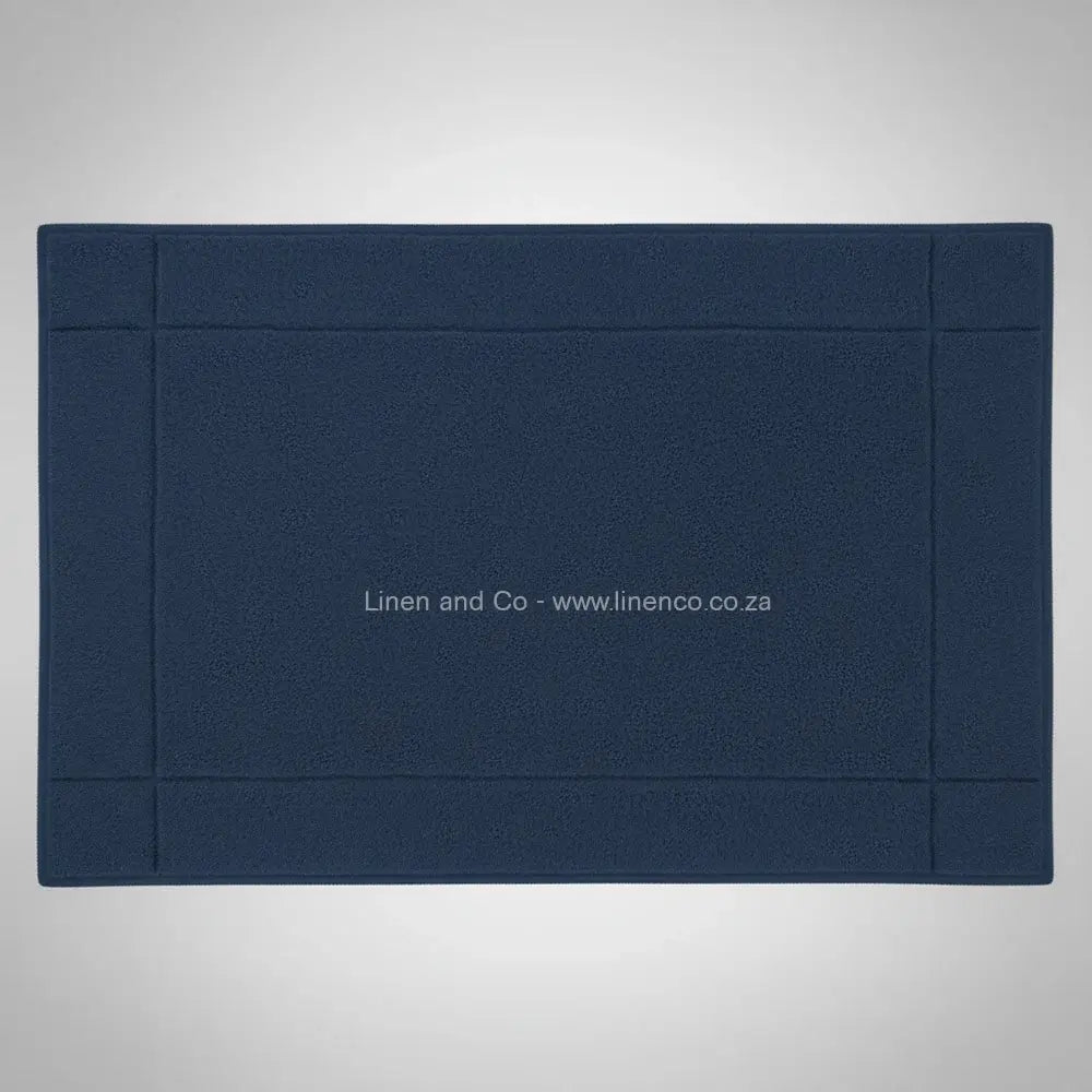 High-quality navy bath mat from Linen and Co's Glodina range, illustrating superior absorbency and commercial-grade performance for hospitality environments