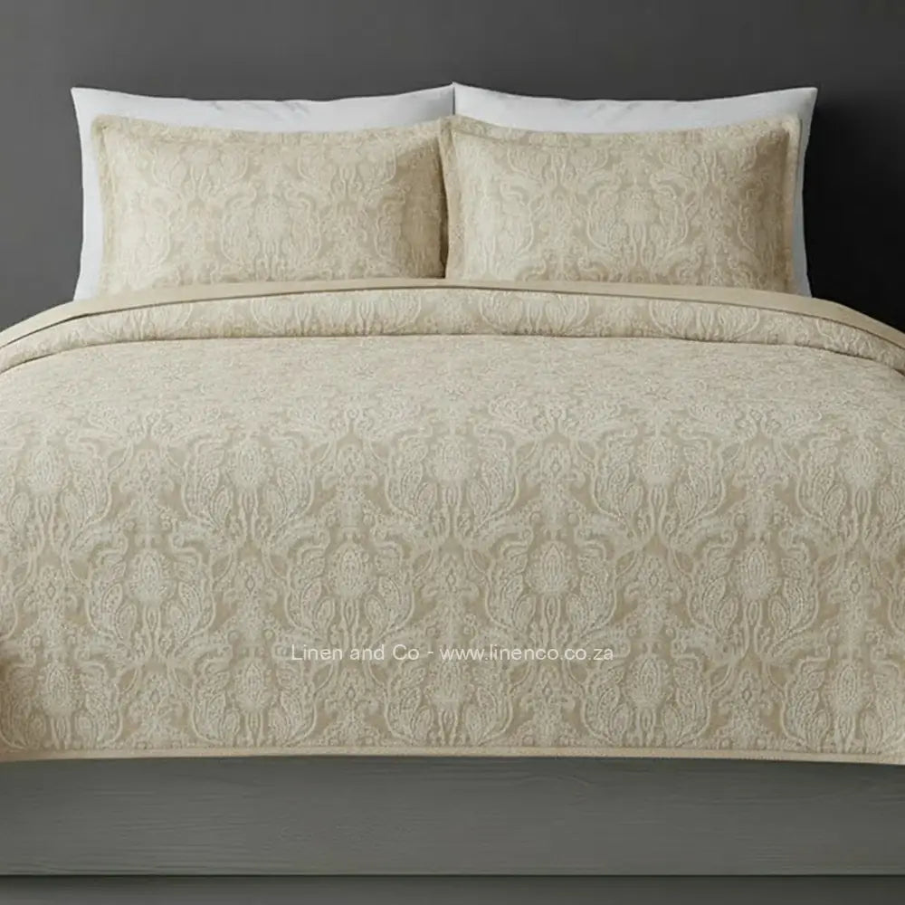 Beige/NaturalKensington Jacquard Bedspread Set with intricate textured pattern, showcasing quilted comforter and matching pillows against a dark background, highlighting sophisticated hospitality textile design by Linen and Co