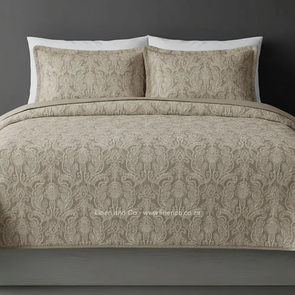 Stone, Kensington Jacquard Bedspread Set with intricate textured pattern, showcasing quilted comforter and matching pillows against a dark background, highlighting sophisticated hospitality textile design by Linen and Co