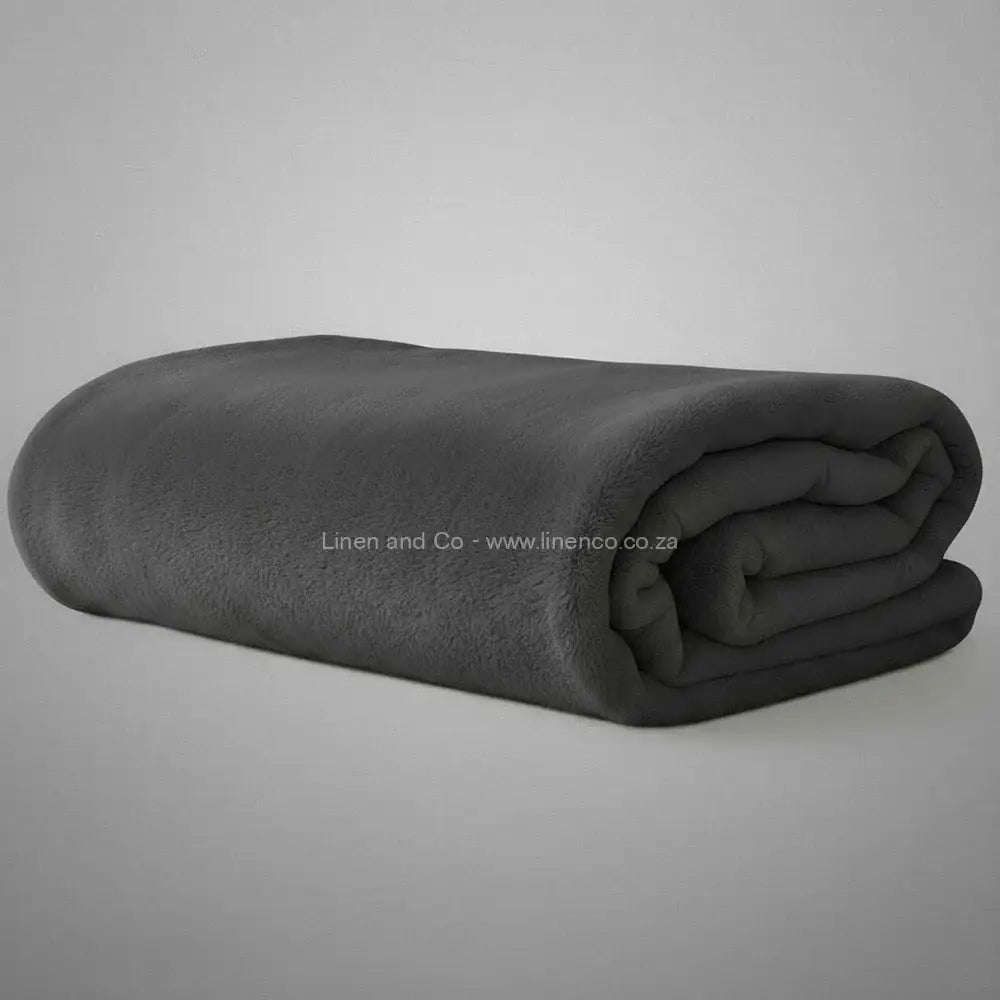 Grey Belfiore luxury blanket neatly folded on light grey background - premium hospitality textile.