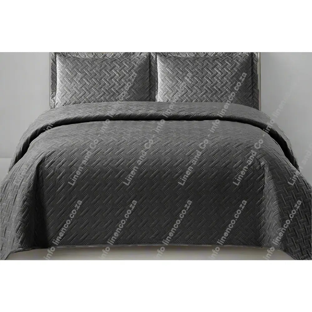 Grey Italian Velvet quilted bedspread set on a bed with matching pillows