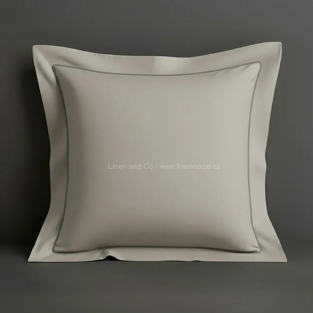 Stone oxford pillow case with one row satin stitch detail on a grey background. Luxury Hotel Linen by Linen and Co.