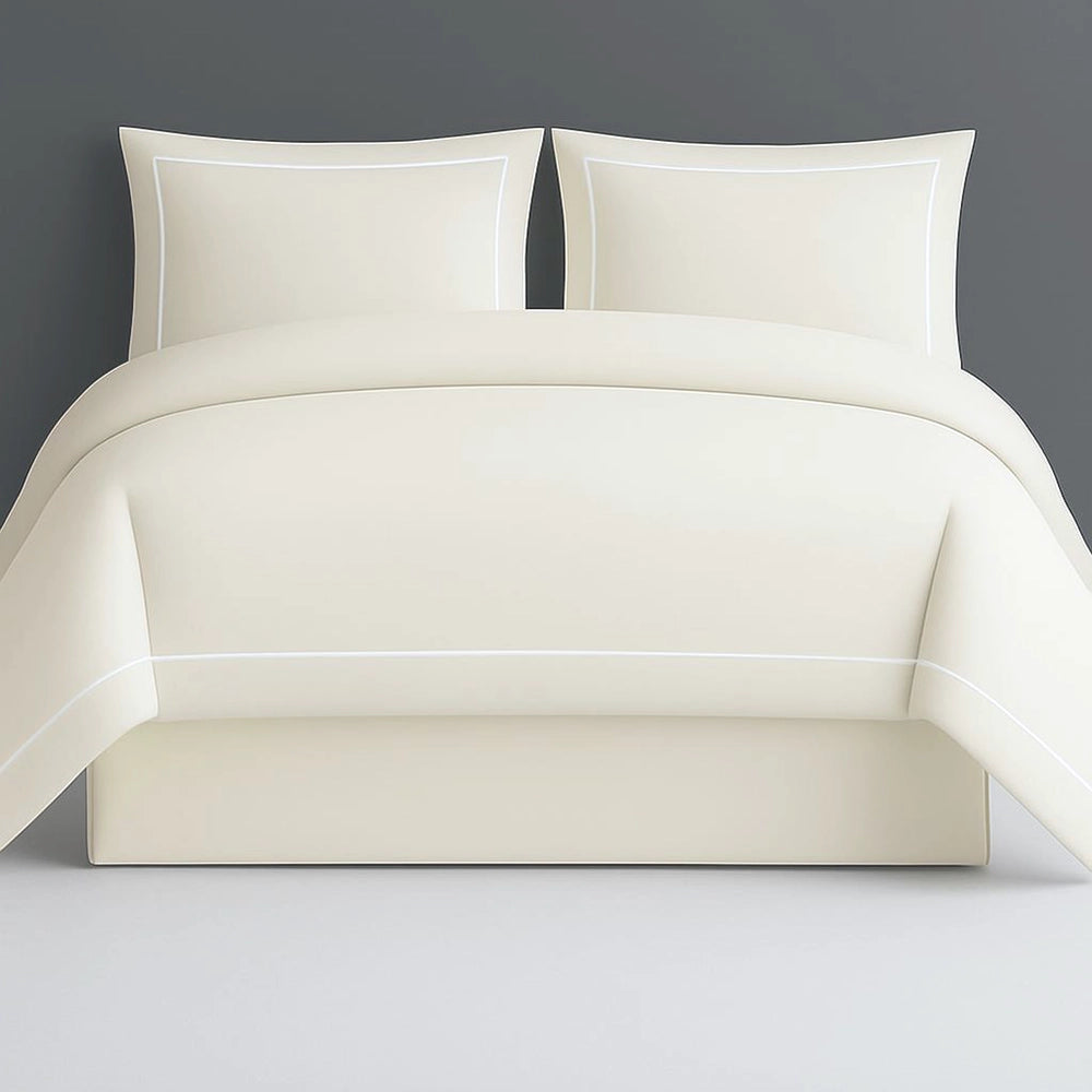 Cream Oxford percale duvet cover set with elegant one-row white satin stitch detailing. 200 thread count luxury bedding, showcasing refined craftsmanship for high-end hospitality and sophisticated residential interiors. Soft neutral tone with subtle textural accent.