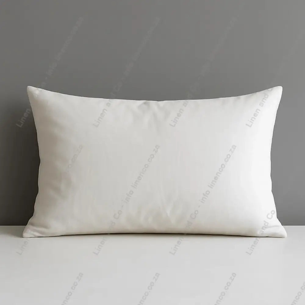 Microfibre Down Alternative Standard size pillow on a grey surface with a grey background