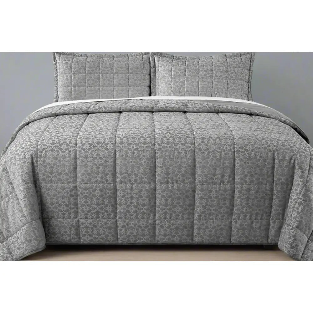 Grey Cologne Design quilted comforter set on a bed with matching pillows.