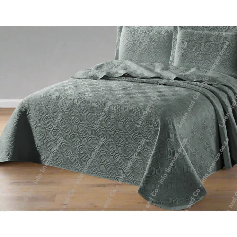 Grey Munich design quilted bedspread textured bedspread on a bed. 