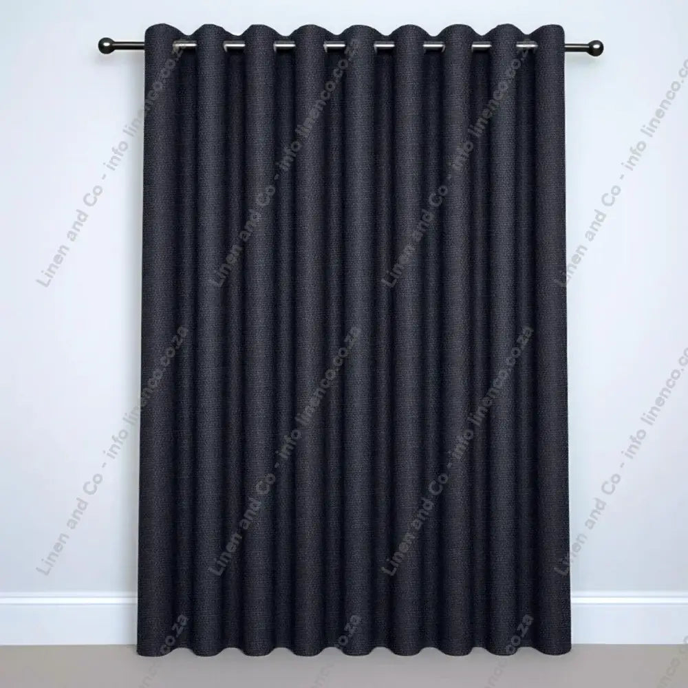 Charcoal Eyelet curtain on a silver curtain rod
