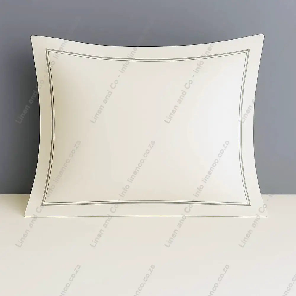 Cream continental pillow case with two row satin stitch on a grey background.