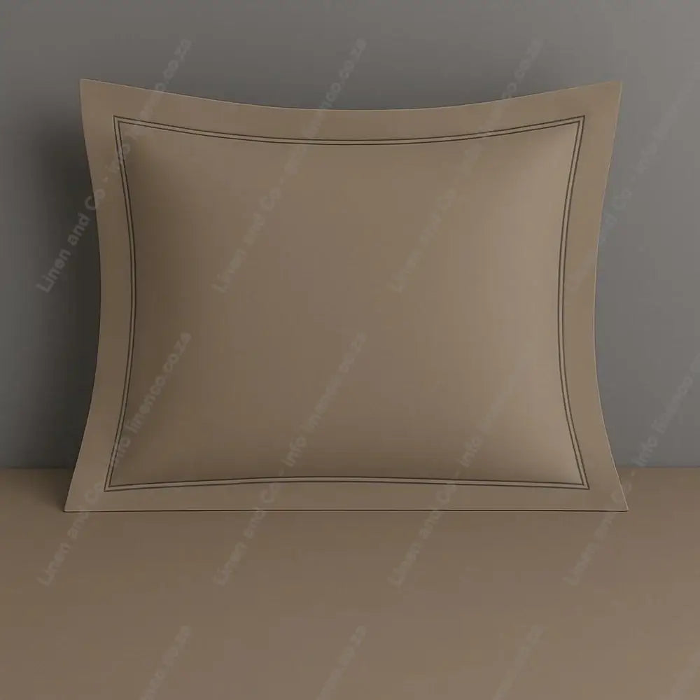 Stone continental pillow case with two row satin stitch on a grey background.